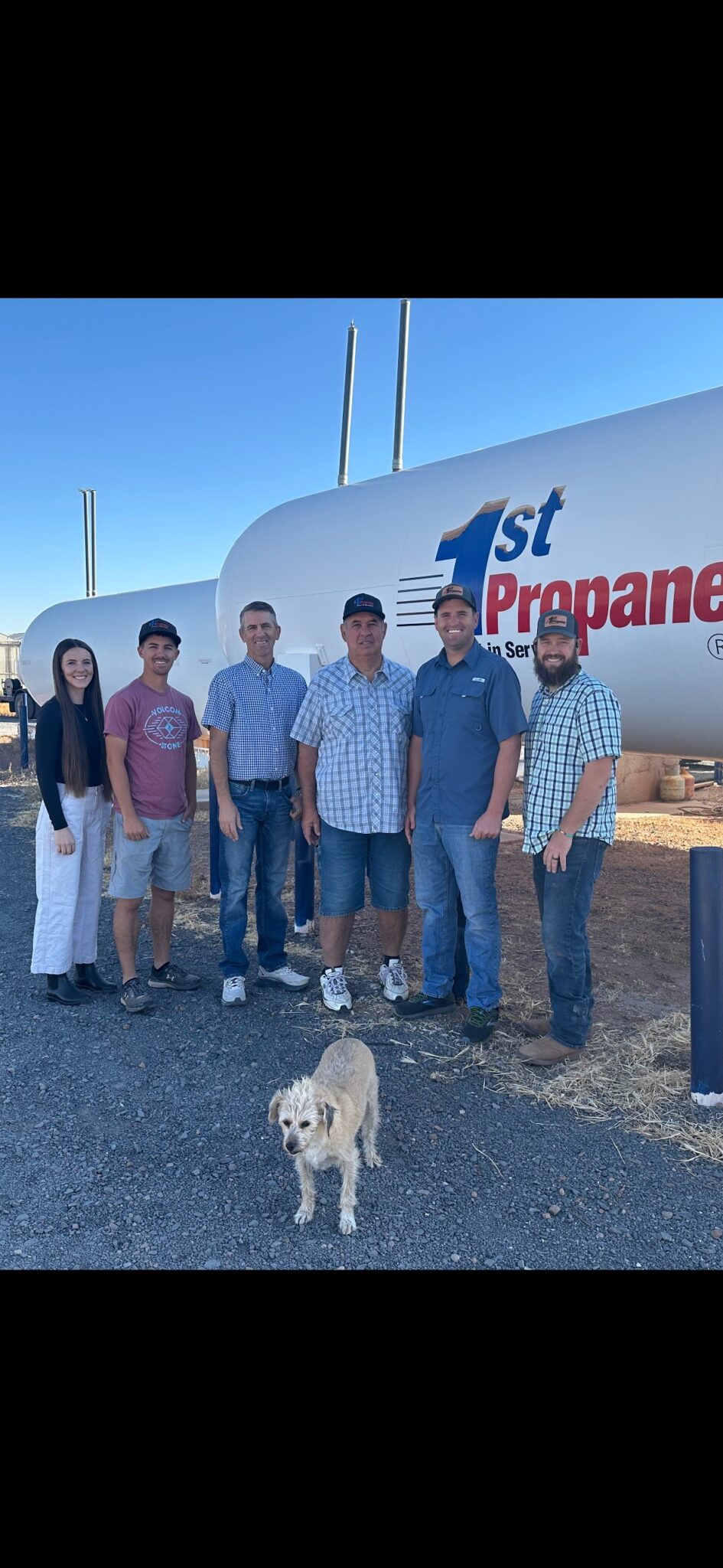 The 1st Propane Crew standing in front of a tank.